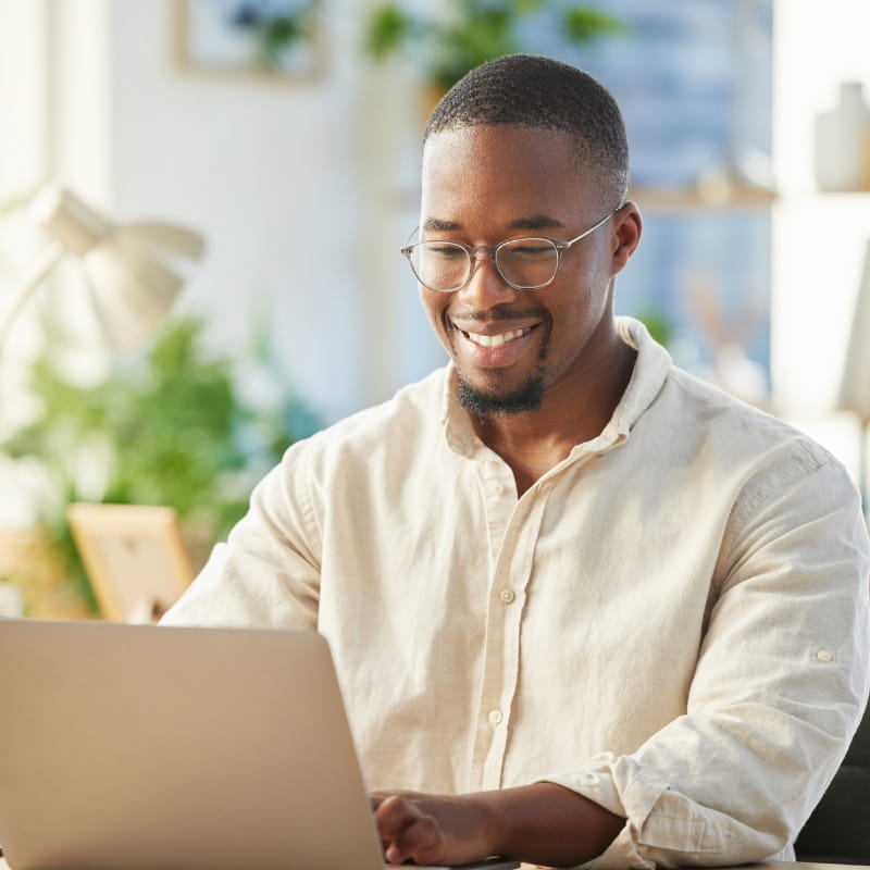 Smiling man using laptop