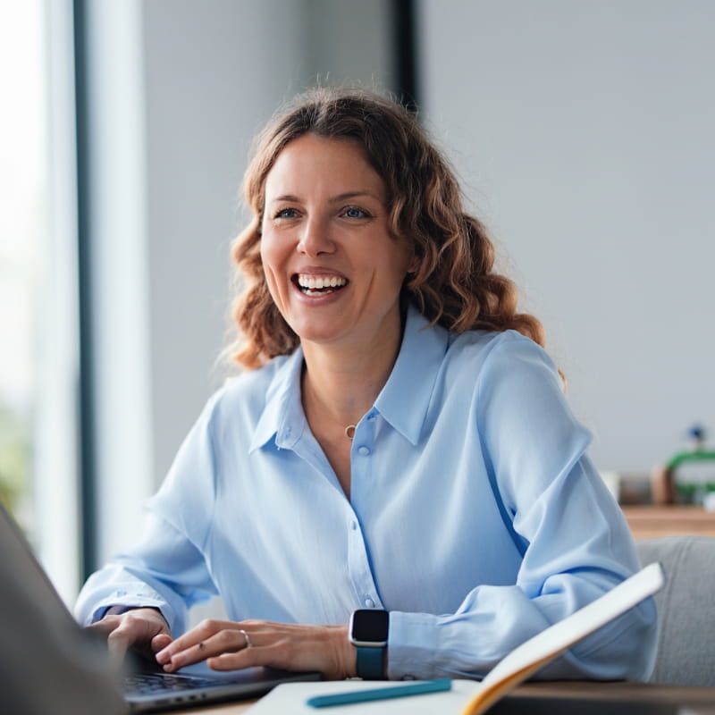 Smiling businesswoman sitting at desk
