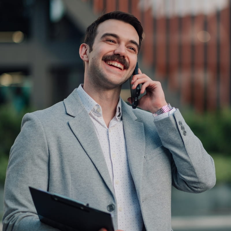 Man talking on phone while carrying tablet
