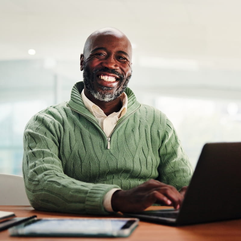 Smiling man using laptop