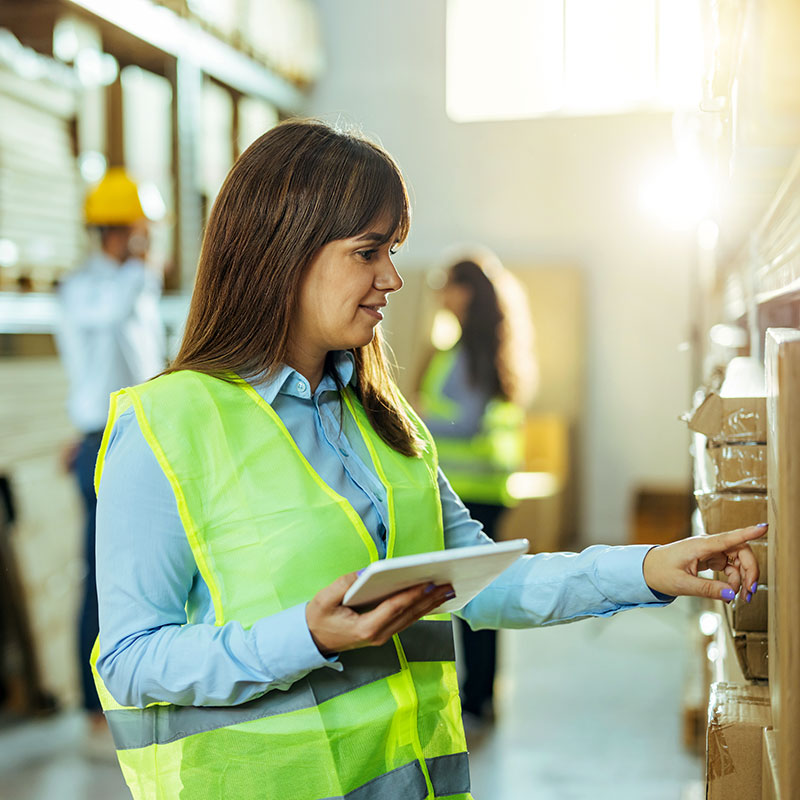 Woman in high vis using a tablet