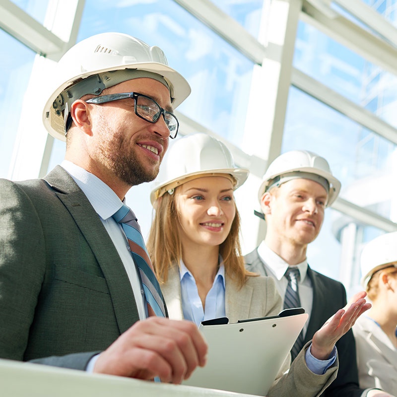 Three colleagues in hard hats