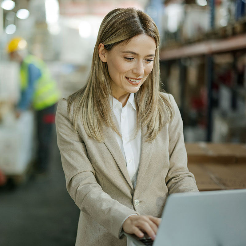 Smiling woman sitting in front of laptop