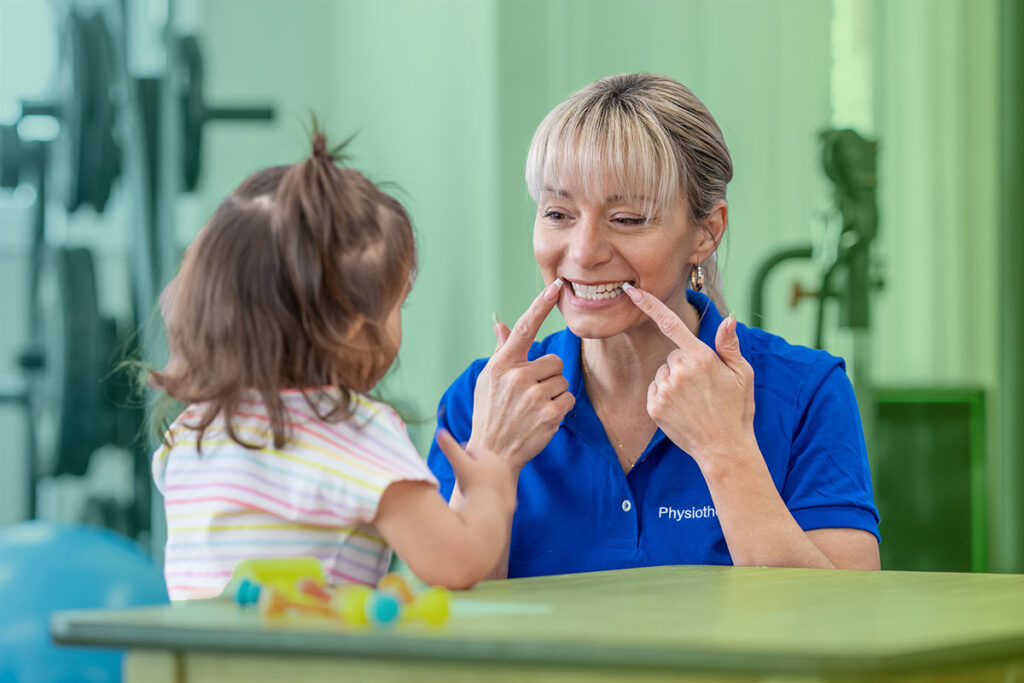 speech therapist working with young girl