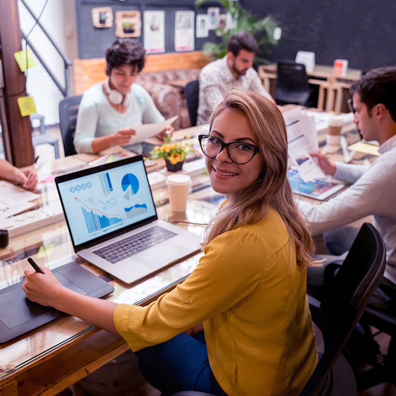 happy lady in a work meeting taking their business to the next level