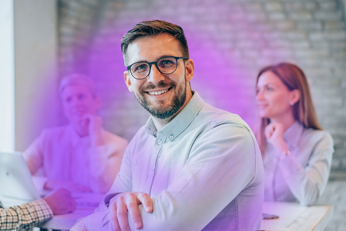 Smiling man sitting in a meeting room