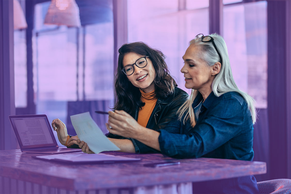 HR professional discussing a business audit with a business woman