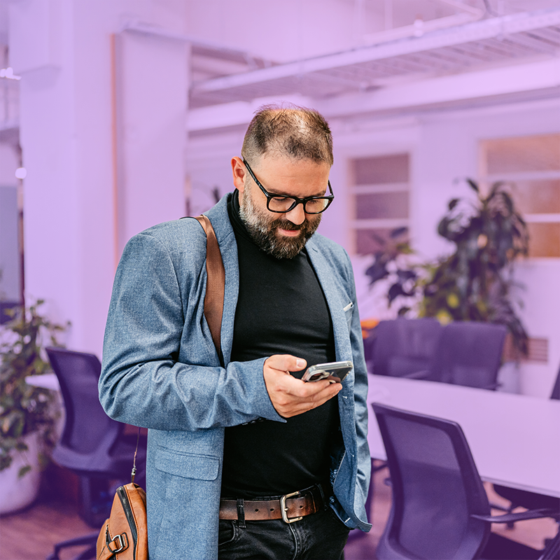 Man using mobile phone in modern office