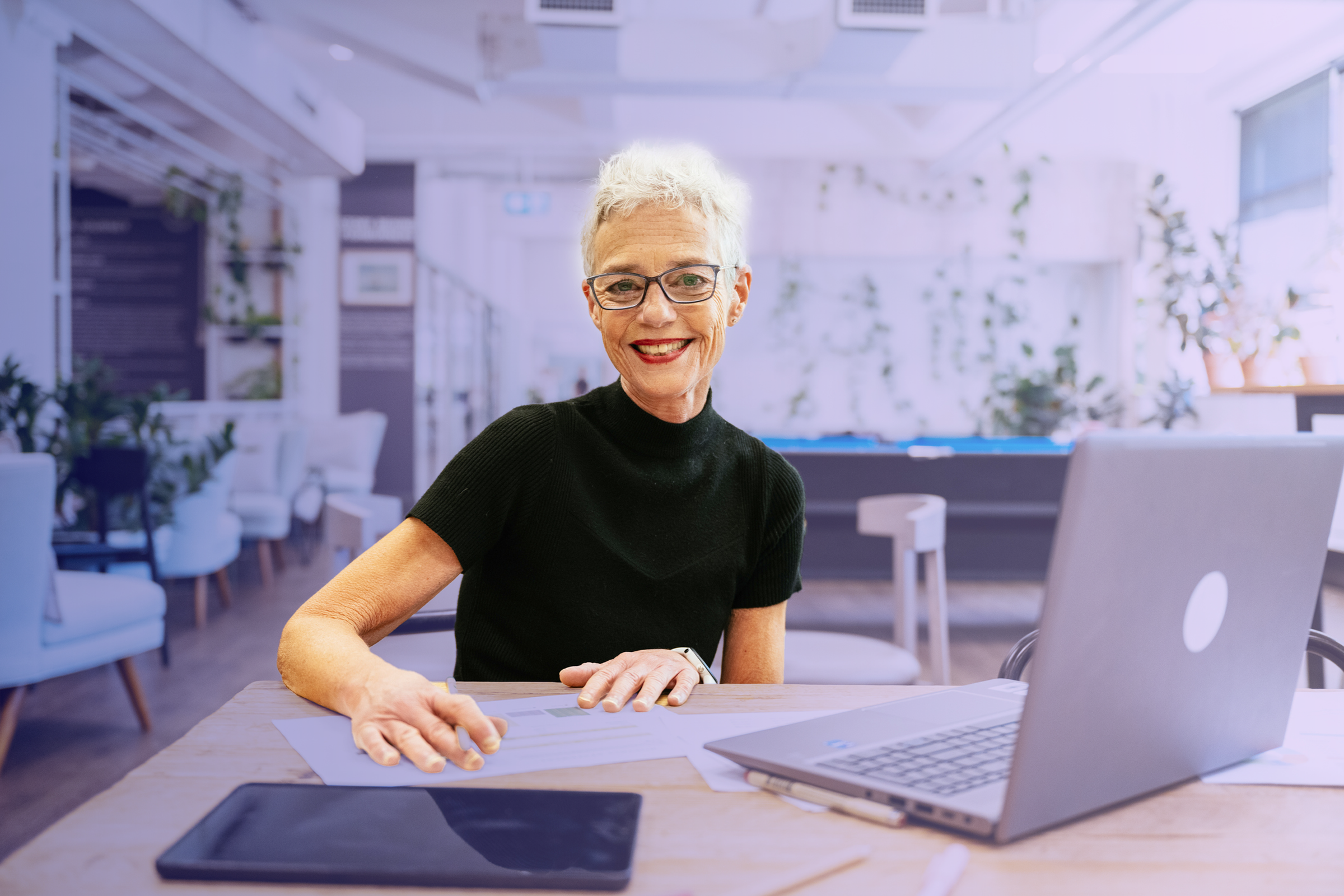 Business owner using payroll software in modern office