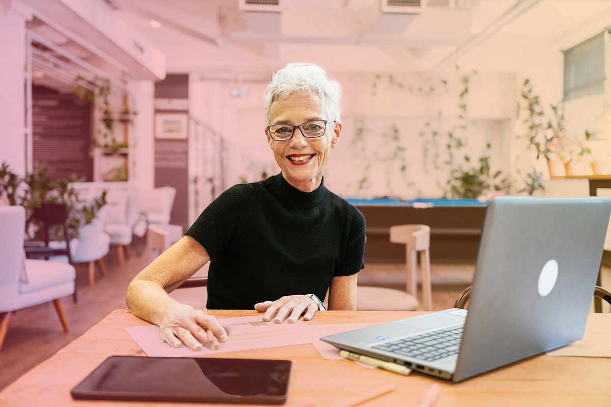 Business owner using payroll software in modern office