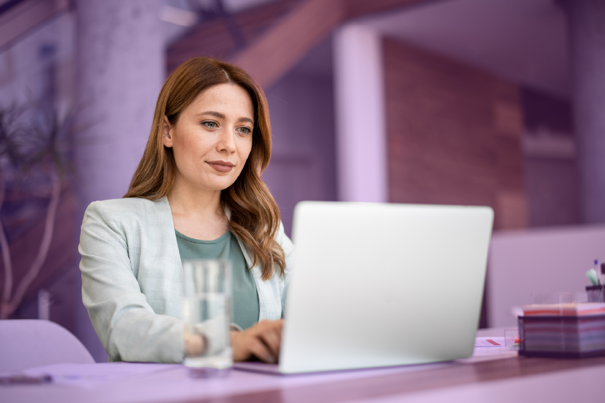Woman using employee database software on a laptop