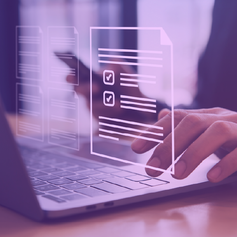 Close up of hands using a laptop and mobile phone