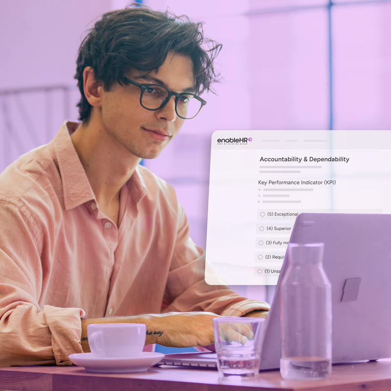 Man using employee management software on laptop