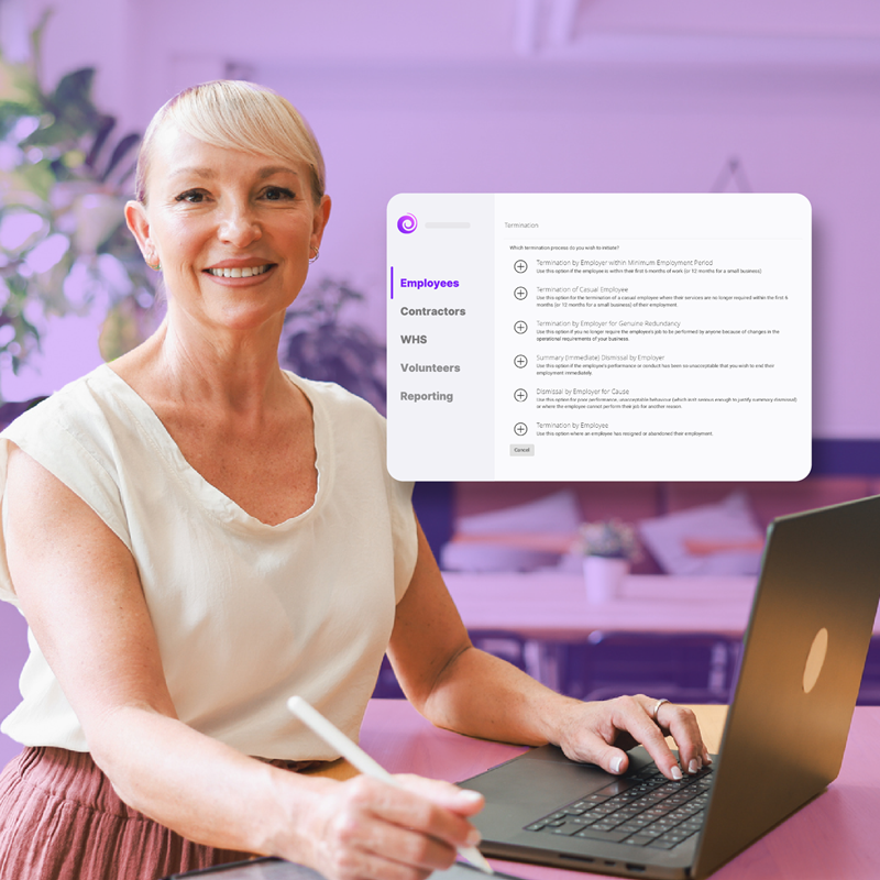 HR manager taking down notes while using a laptop