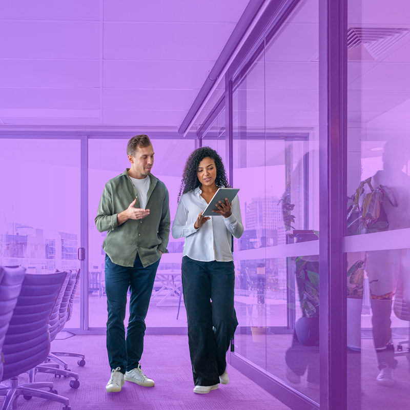 Colleagues walking and chatting in a modern office setting