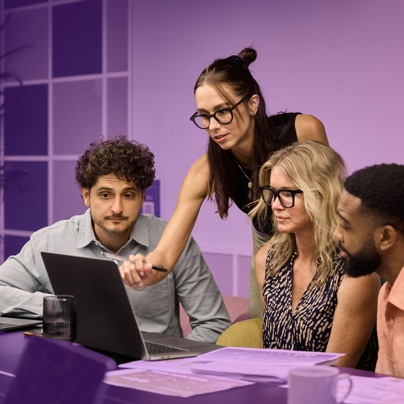 HR team reviewing documents on a laptop