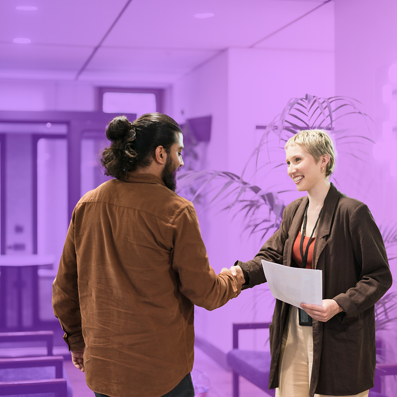 Small business owner shaking hands with HR manager