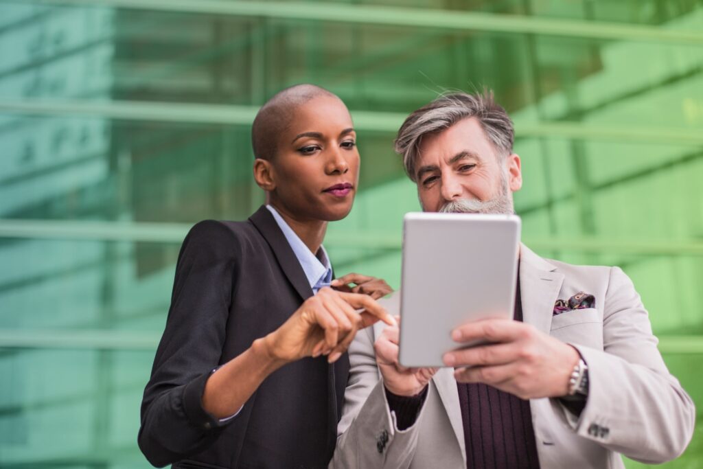Colleagues holding a tablet in an office setting