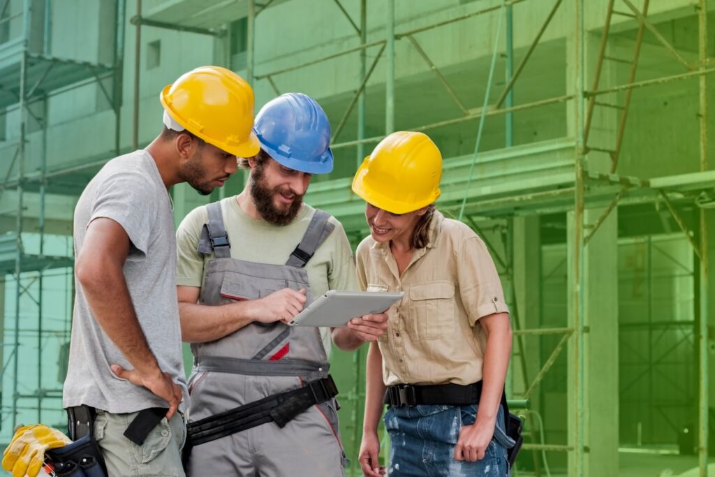 Three colleagues in hard hats