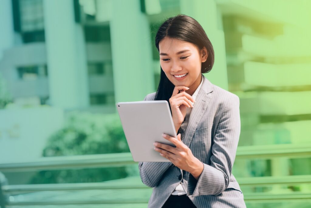 Smiling woman holding a tablet in an office setting