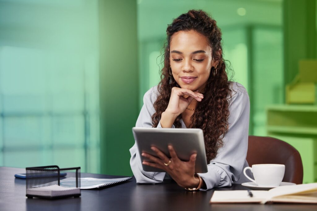 Smiling woman holding a tablet in an office setting