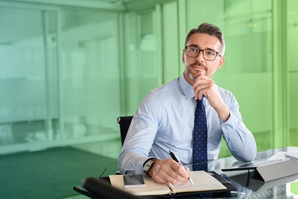 Man writing notes at a desk