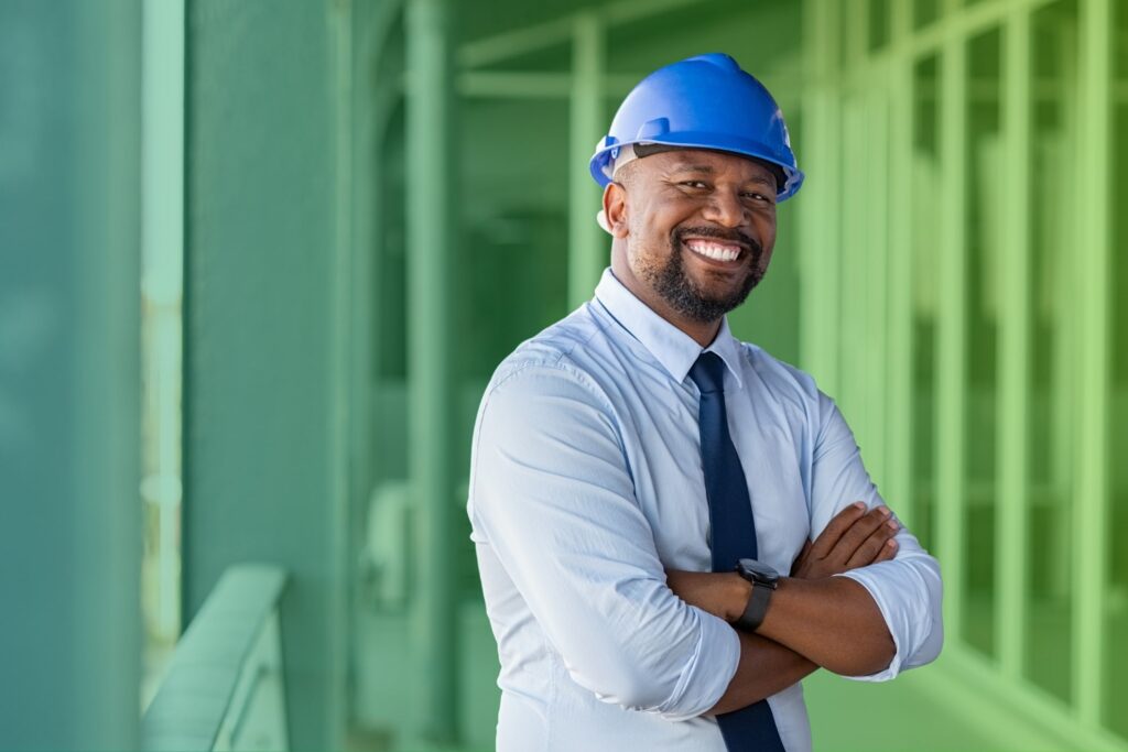 Smiling man with arms folded