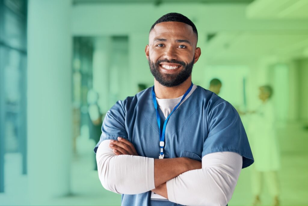 Smiling man with arms folded