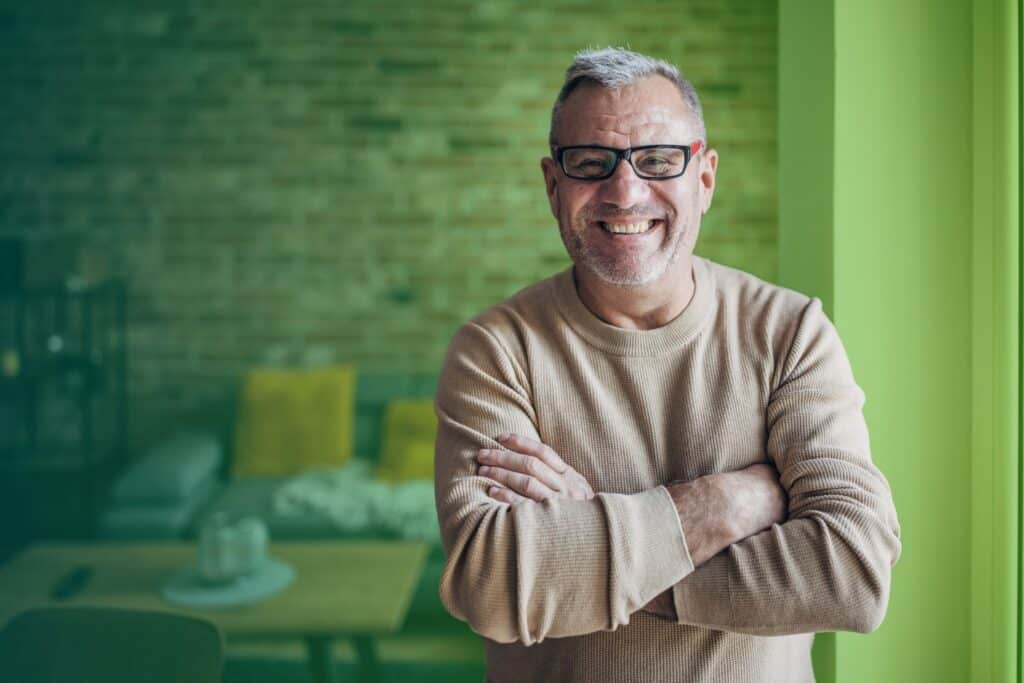Smiling man with arms folded