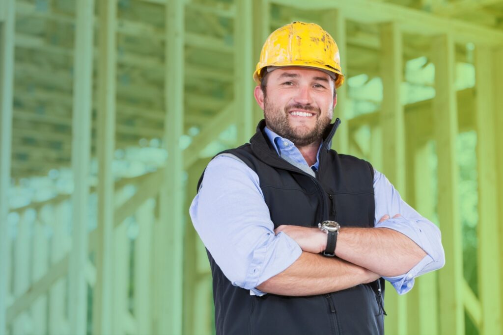 Smiling man with arms folded