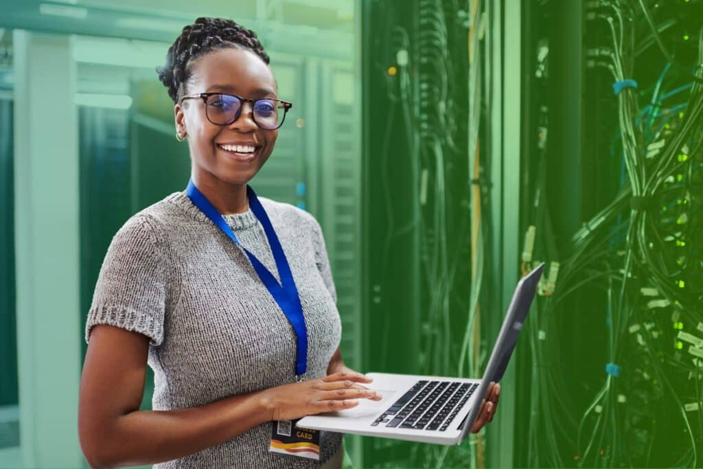 Smiling woman using a laptop in an office setting