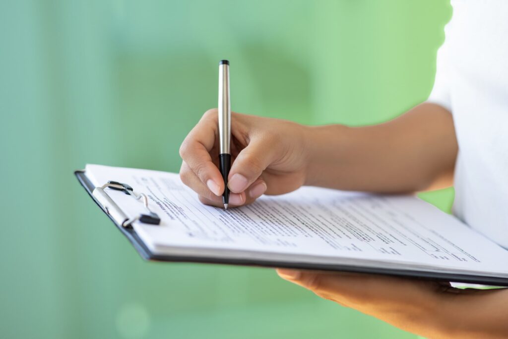 Close up of notes being written on a clipboard