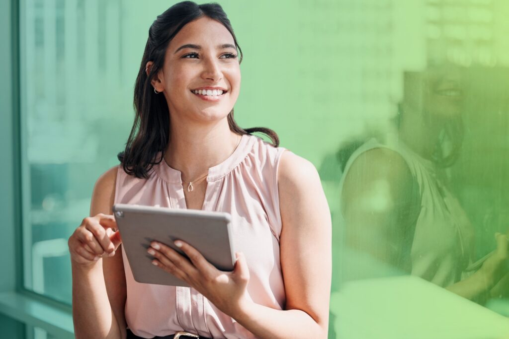 Smiling woman holding a tablet in an office setting
