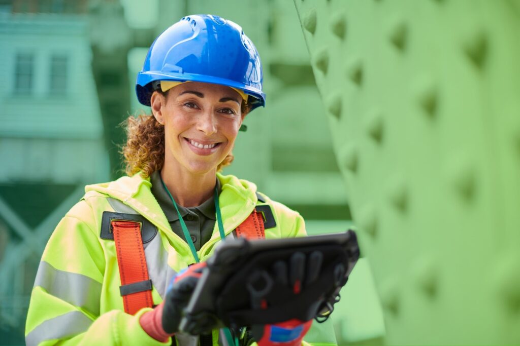 Woman in hard hat using a tablet