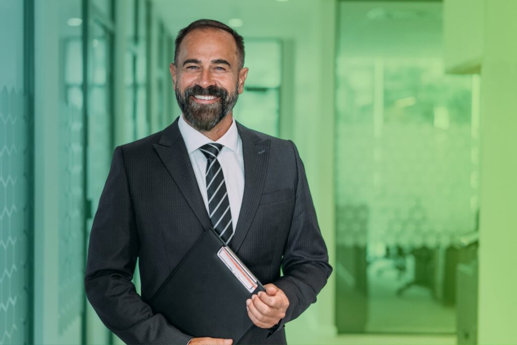 Businessman smiling and carrying notes