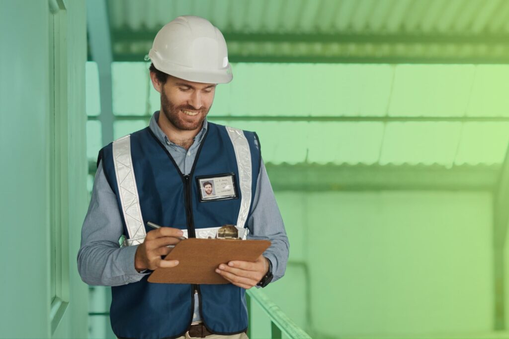 Man in high vis using a clipboard