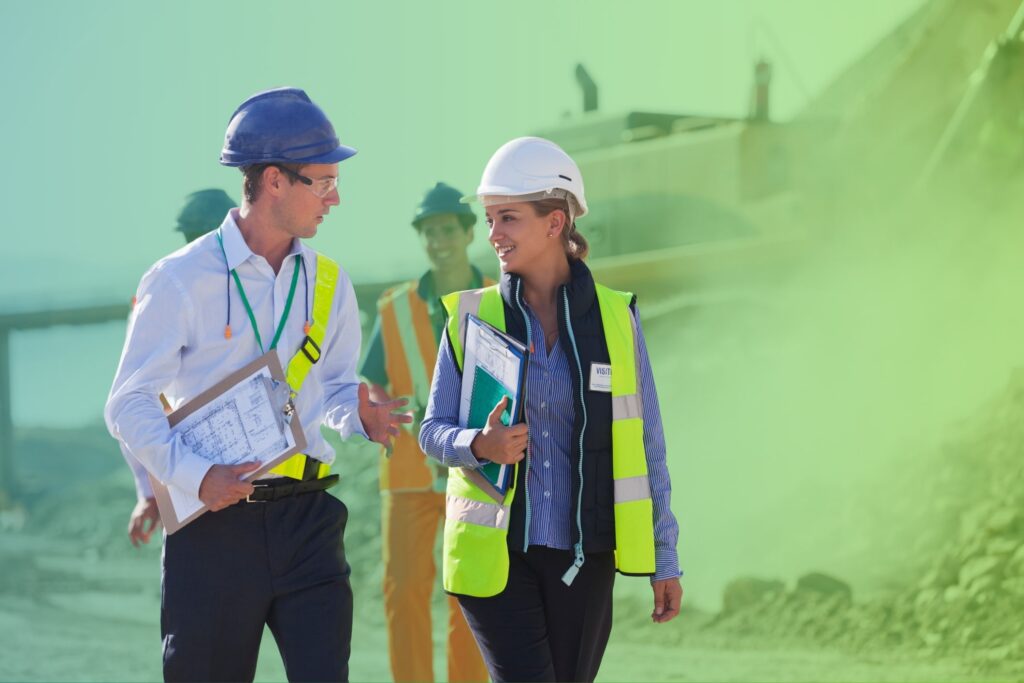 Colleagues in suits and hard hats walking on a jobsite