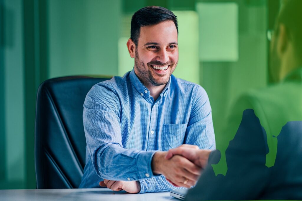 Smiling man shaking hands with someone