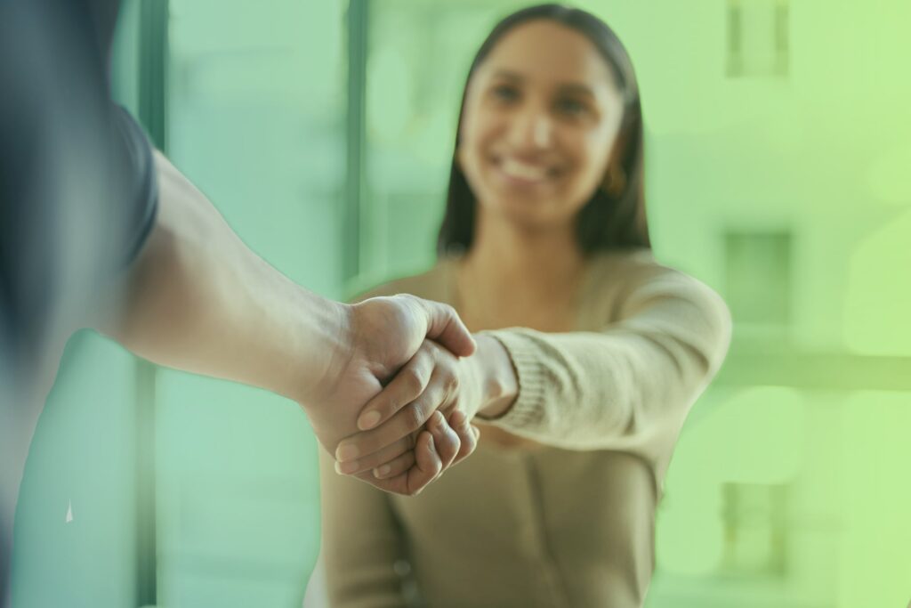 Smiling woman shaking hands