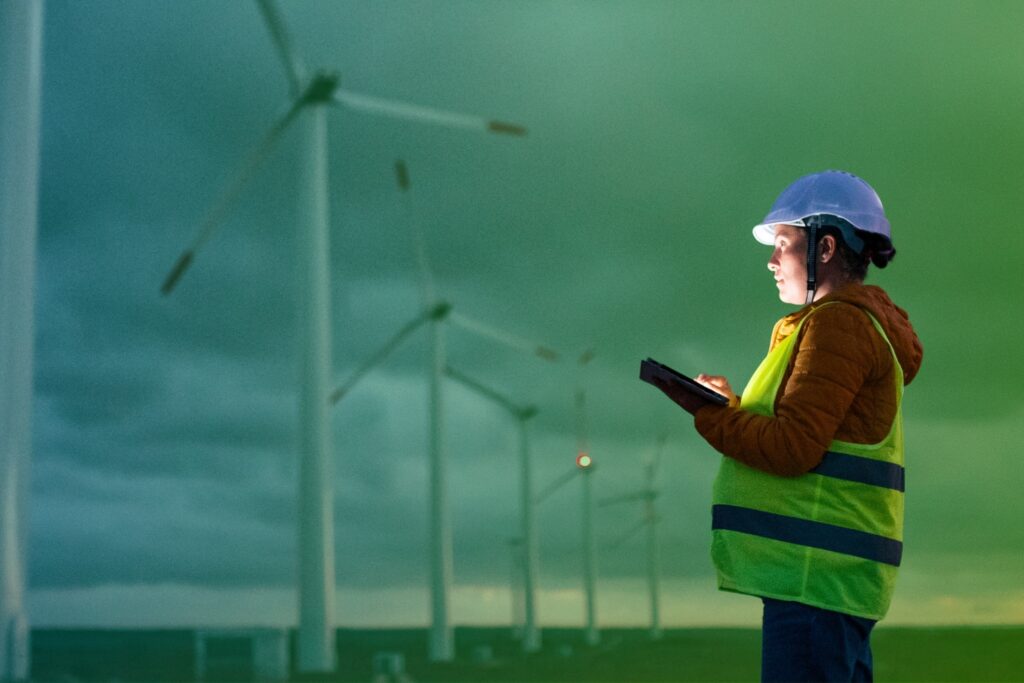 Woman in a hard hat taking notes