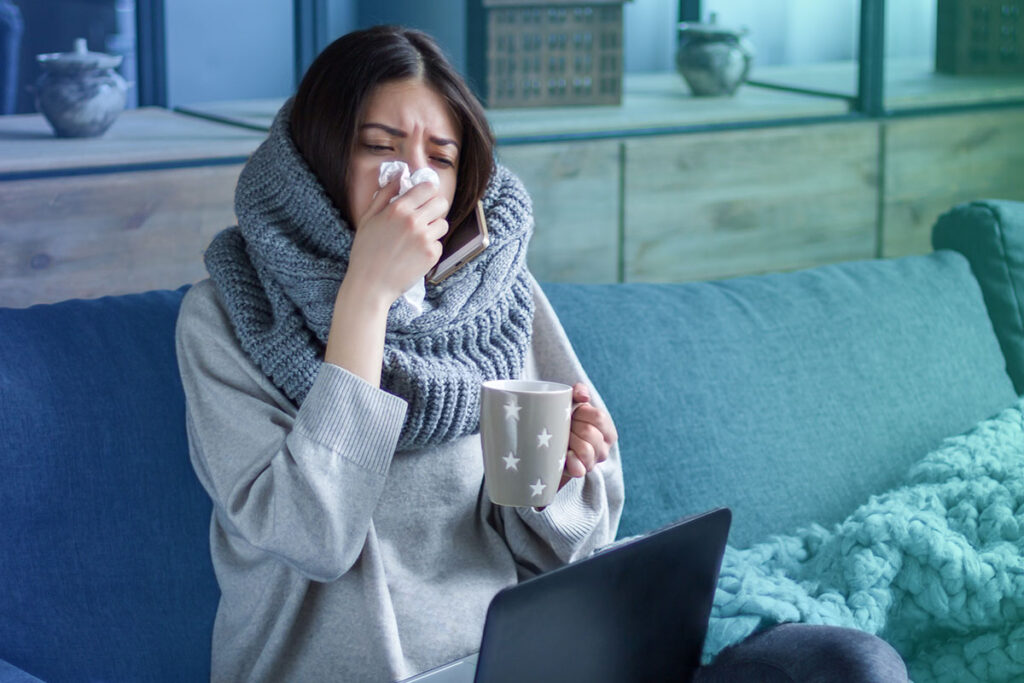 Sick woman sitting on a couch