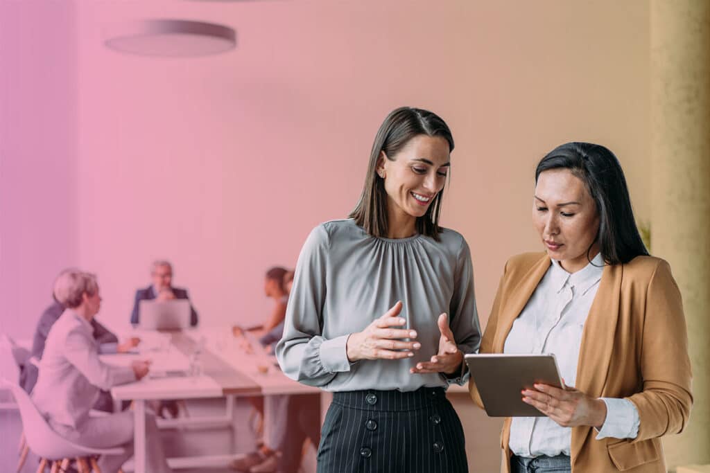 Colleagues chatting in a meeting room