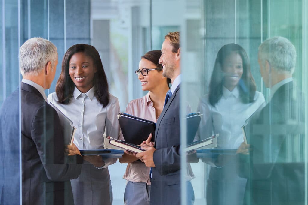 Colleagues chatting in a meeting room