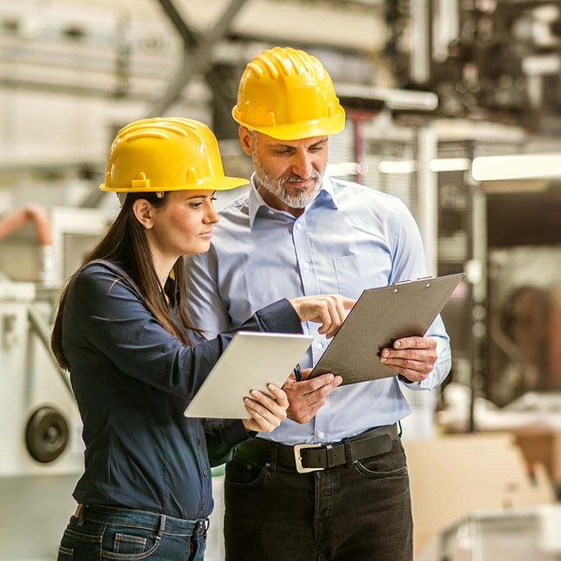 Two colleagues in hard hats